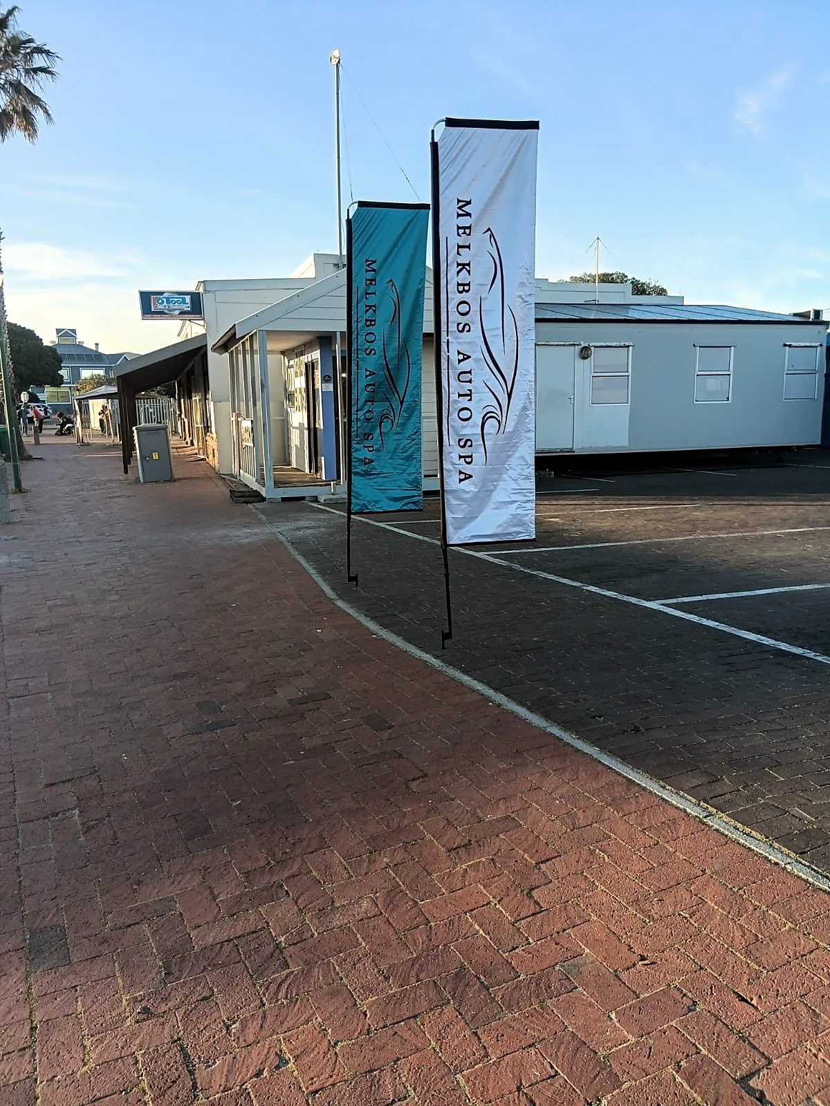 The Melkbos Auto Spa flags on the street outside the branch